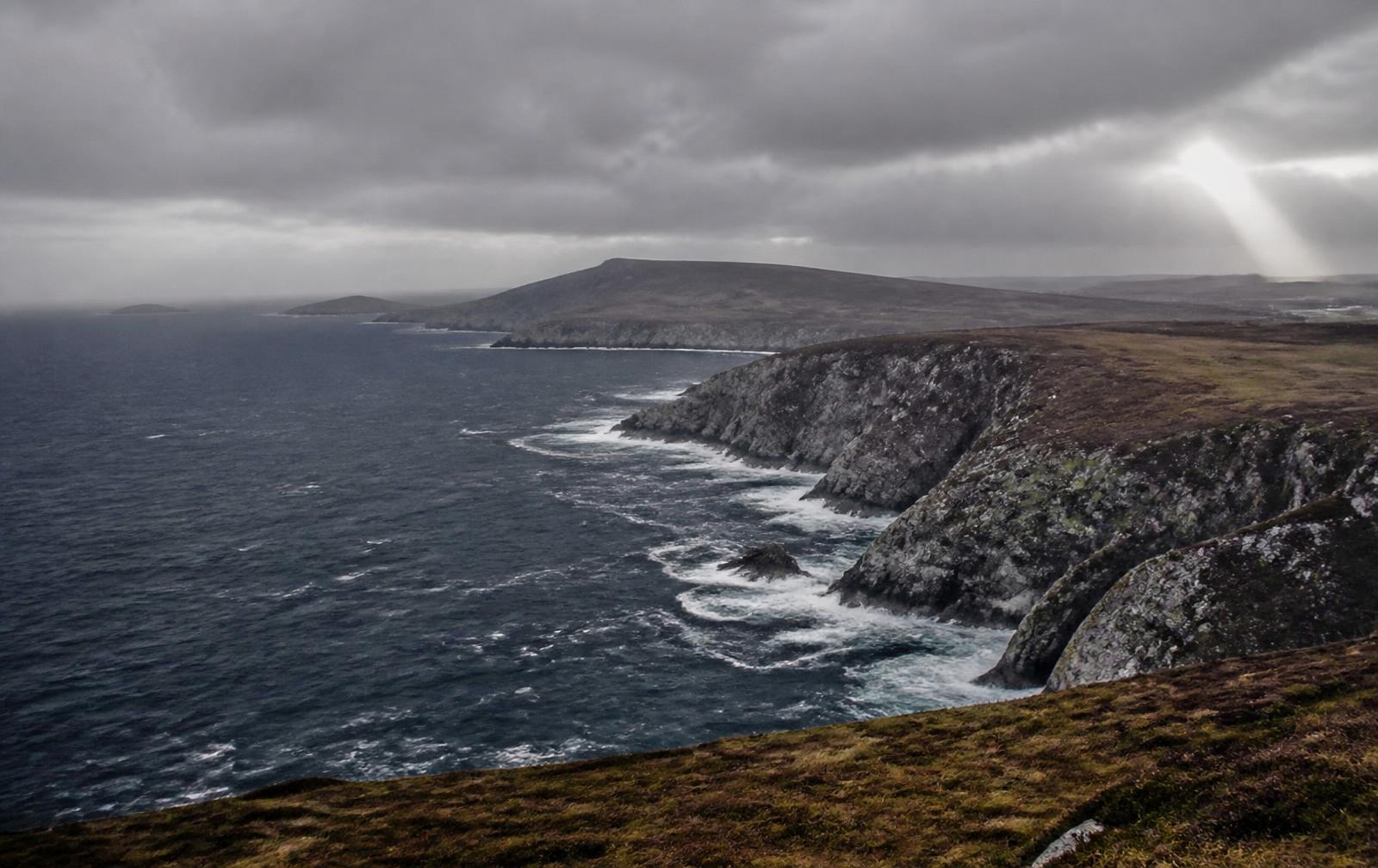Sea cliffs and heather-covered bog on an exposed north-western Atlantic coastline.